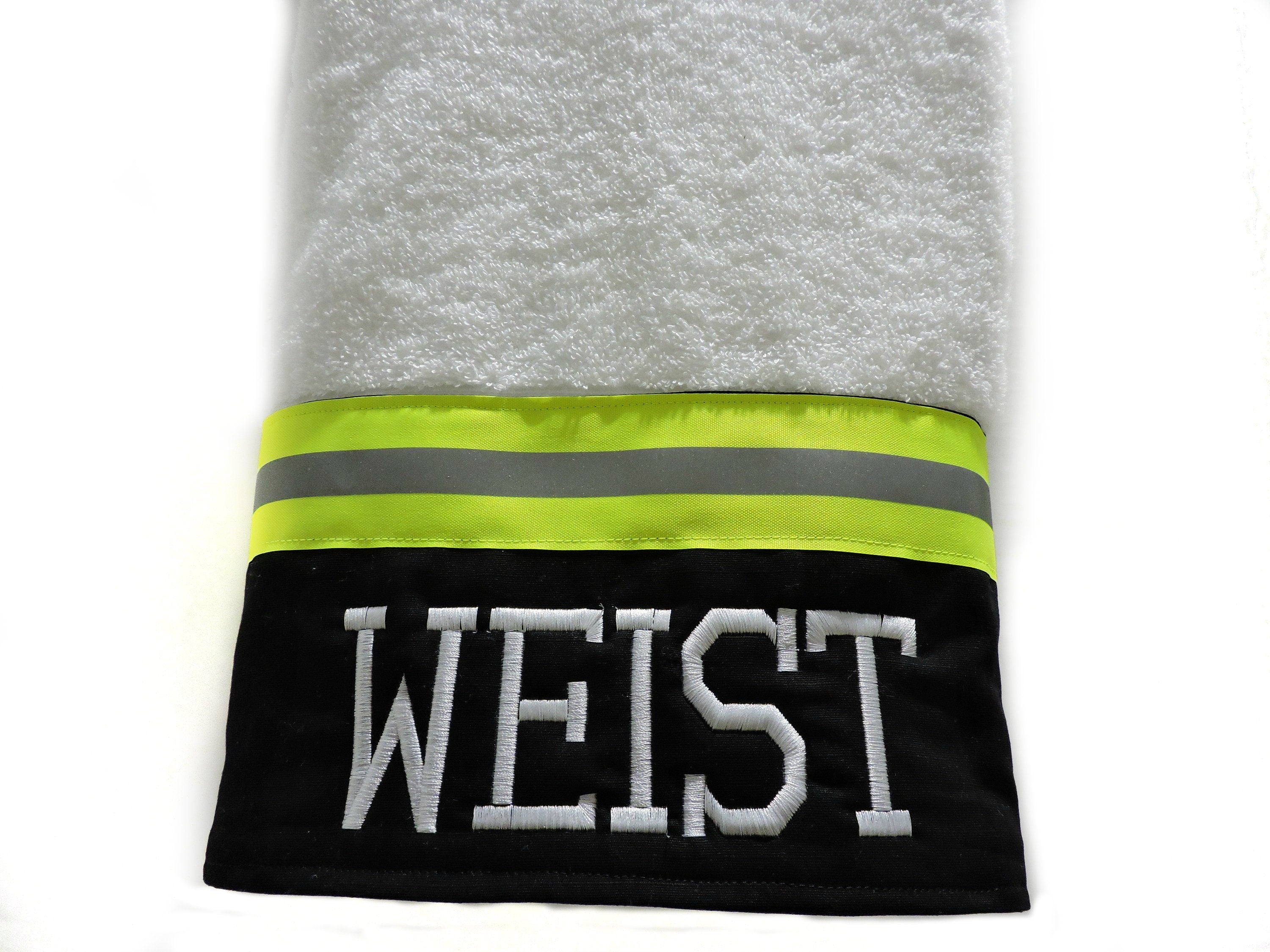 black fabric with neon yellow reflective tape firefighter bath towel with a name added
