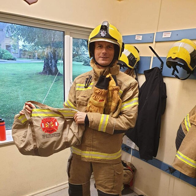firefighter with a firefighter duffel bag