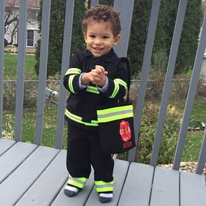 toddler holding Firefighter Toddler Trick or Treat bag
