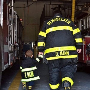 Toddler wearing Firefighter toddler jacket  with name added back view