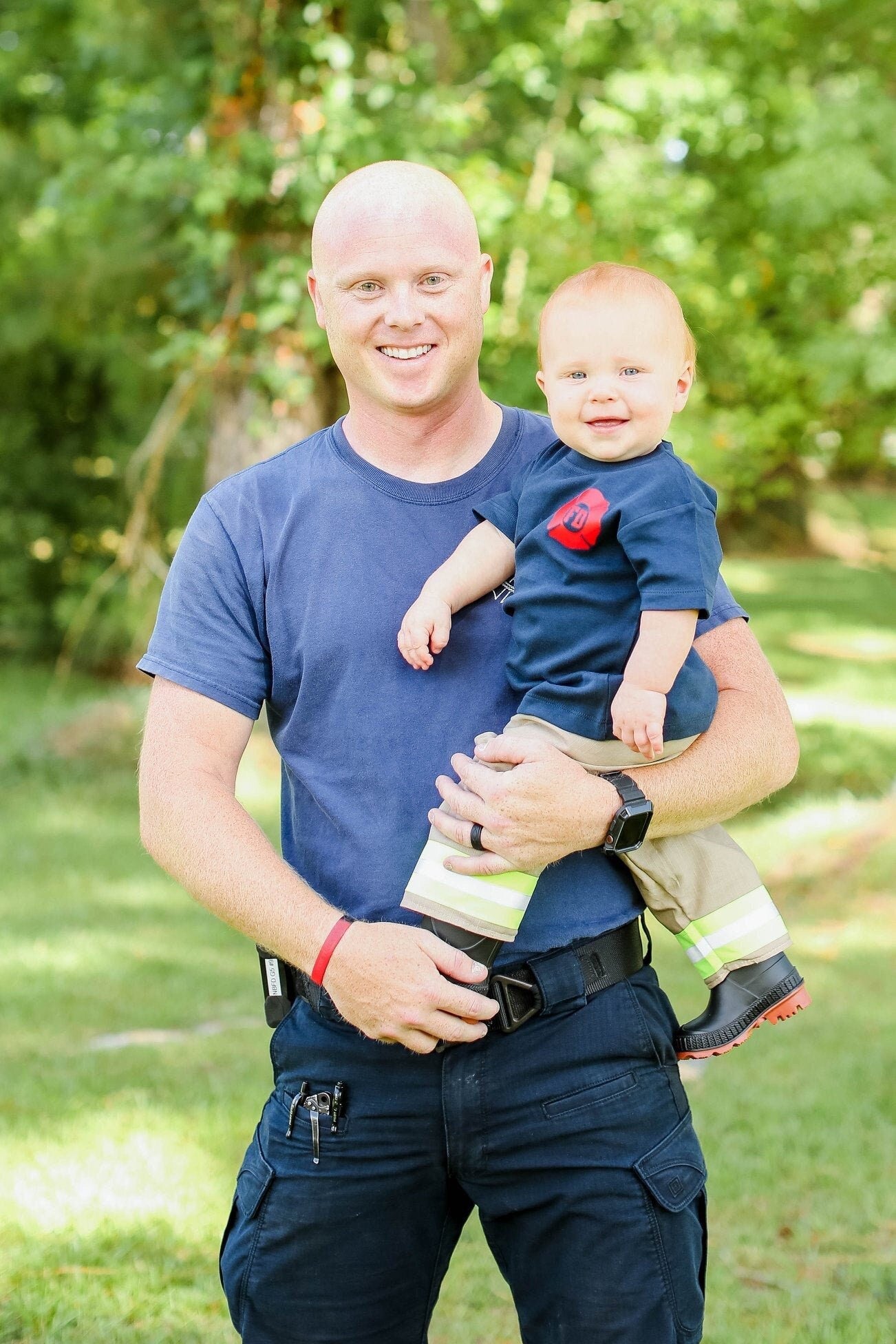 baby wearing blue shirt with maltese cross firefighter shirt 